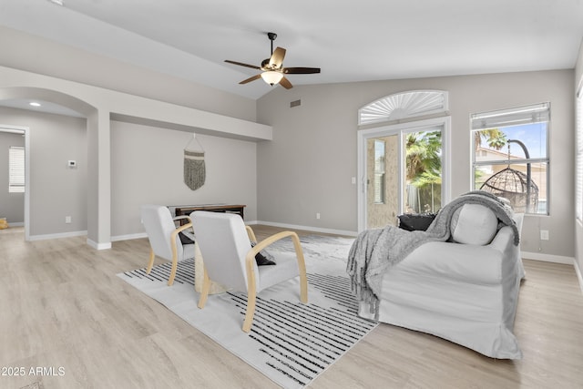 512 W Encinas St, Gilbert, AZ 85233 - living room featuring arched walkways, ceiling fan, light wood finished floors, lofted ceiling, and baseboards