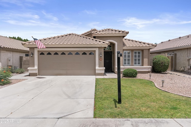 512 W Encinas St, Gilbert, AZ 85233 - mediterranean / spanish house featuring an attached garage, concrete driveway, a front yard, a tiled roof, and stucco siding