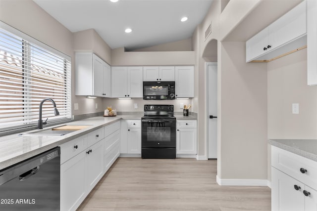 512 W Encinas St, Gilbert, AZ 85233 - kitchen featuring black appliances, a sink, white cabinets, light wood-type flooring, and vaulted ceiling
