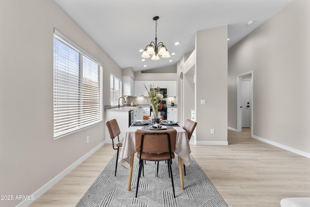 512 W Encinas St, Gilbert, AZ 85233 - dining space with a chandelier, light wood finished floors, vaulted ceiling, baseboards, and recessed lighting