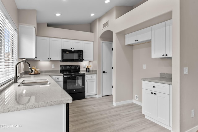 512 W Encinas St, Gilbert, AZ 85233 - kitchen with black appliances, a sink, white cabinetry, baseboards, and light stone countertops