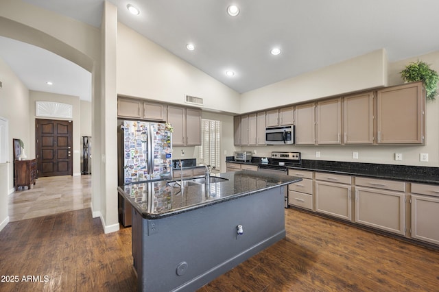 15064 N 54th Way, Scottsdale, AZ 85254 - kitchen featuring stainless steel appliances, a sink, dark stone counters, a center island with sink, and dark wood-style floors