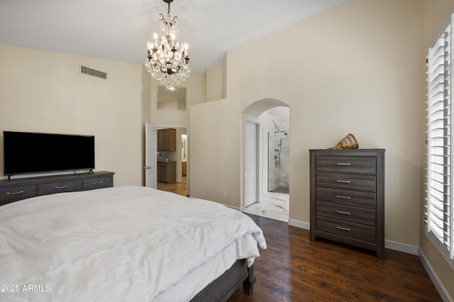 15064 N 54th Way, Scottsdale, AZ 85254 - bedroom featuring arched walkways, dark wood-style floors, a chandelier, baseboards, and a towering ceiling