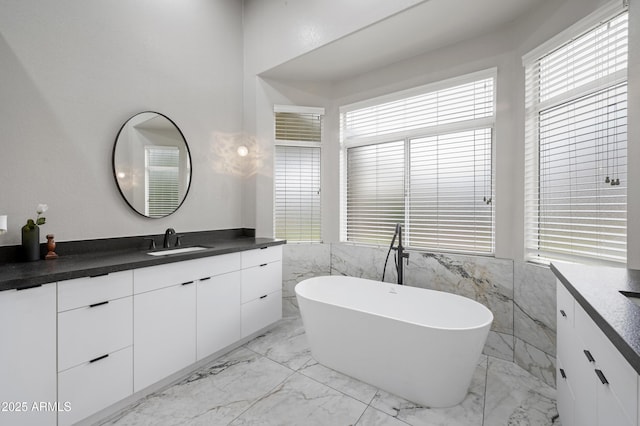 15064 N 54th Way, Scottsdale, AZ 85254 - bathroom with marble tiled flooring, vanity, a freestanding tub, and tile walls