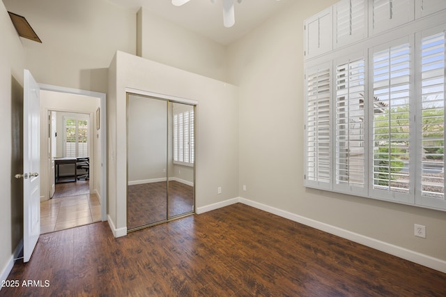15064 N 54th Way, Scottsdale, AZ 85254 - unfurnished bedroom featuring dark wood finished floors, a closet, and baseboards