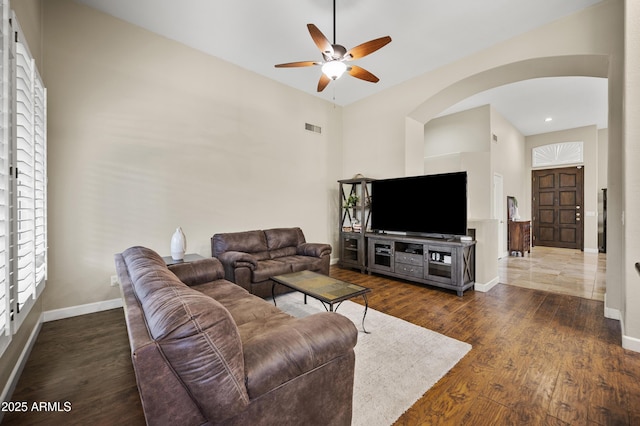 15064 N 54th Way, Scottsdale, AZ 85254 - living area featuring ceiling fan, arched walkways, dark wood-style flooring, and baseboards