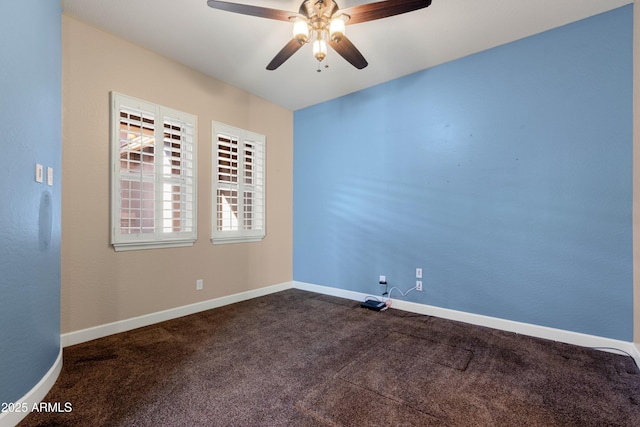 spare room featuring ceiling fan and dark colored carpet