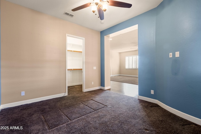 unfurnished room with ceiling fan and carpet flooring