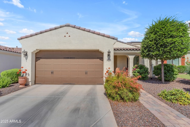 14200 W Village Pkwy Unit 2128, Litchfield Park, AZ 85340 - mediterranean / spanish home featuring stucco siding, an attached garage, concrete driveway, and a tiled roof
