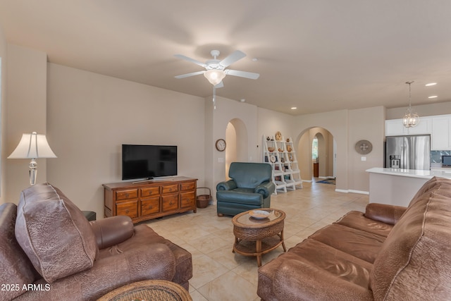 14200 W Village Pkwy Unit 2128, Litchfield Park, AZ 85340 - living room with arched walkways, ceiling fan, light tile patterned floors, and recessed lighting