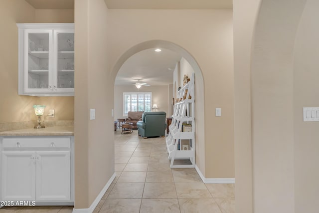 14200 W Village Pkwy Unit 2128, Litchfield Park, AZ 85340 - hallway featuring arched walkways and light tile patterned floors