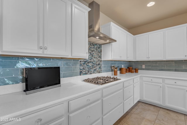 14200 W Village Pkwy Unit 2128, Litchfield Park, AZ 85340 - kitchen with wall chimney exhaust hood, stainless steel gas stovetop, light countertops, white cabinetry, and tasteful backsplash