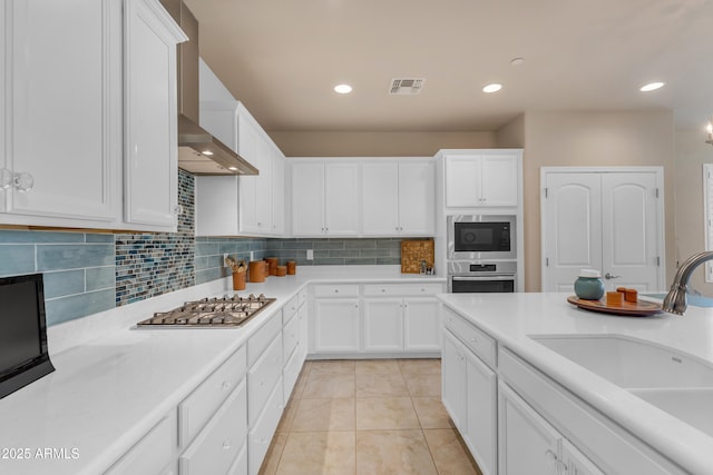 14200 W Village Pkwy Unit 2128, Litchfield Park, AZ 85340 - kitchen with stainless steel appliances, white cabinets, tasteful backsplash, and recessed lighting