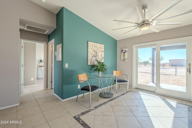 sitting room featuring ceiling fan, light tile patterned flooring, and vaulted ceiling