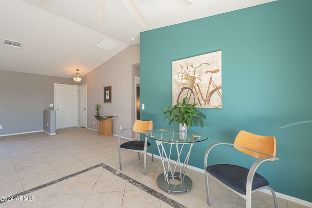 living area with light tile patterned flooring and lofted ceiling