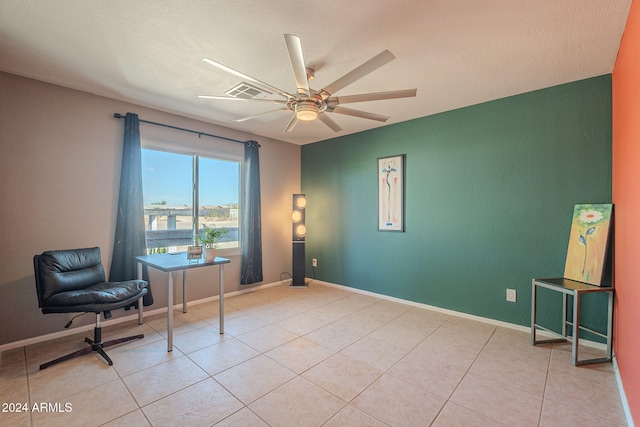 tiled home office featuring ceiling fan