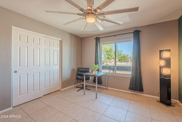 tiled home office featuring ceiling fan