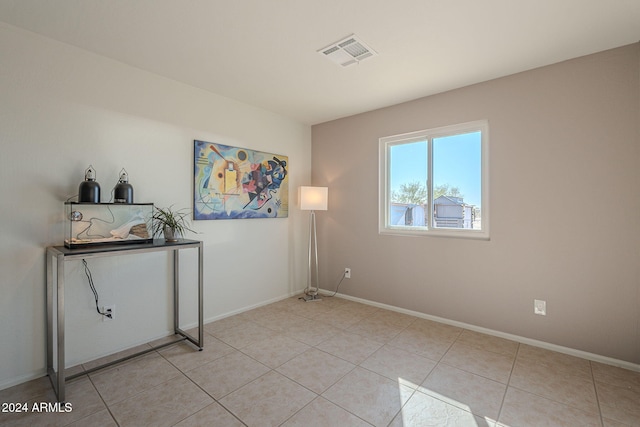 unfurnished room featuring light tile patterned floors