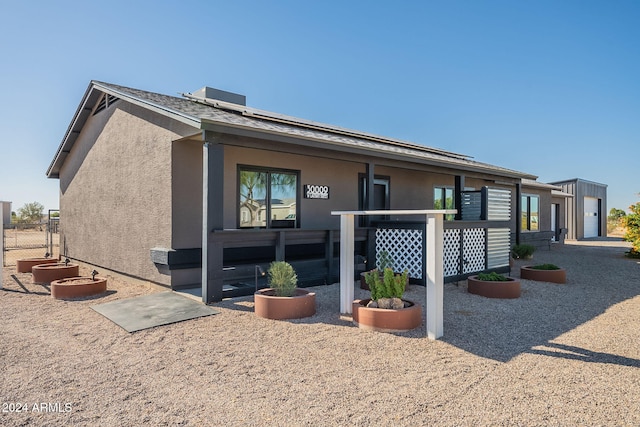 back of property featuring solar panels