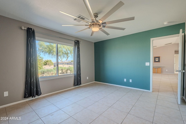 spare room featuring ceiling fan and light tile patterned floors