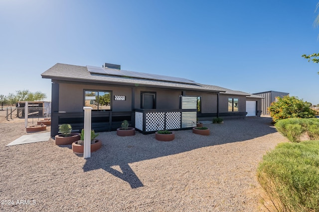 view of front of house with solar panels and a garage