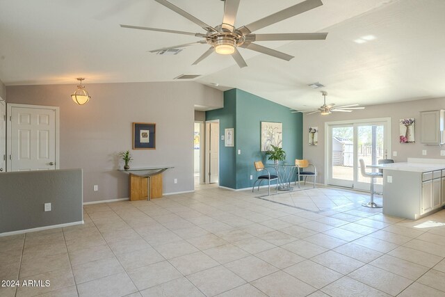 unfurnished living room featuring ceiling fan, light tile patterned floors, and lofted ceiling