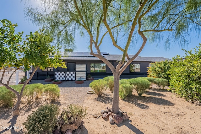 ranch-style house featuring solar panels