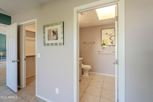 bathroom featuring tile patterned flooring, vanity, and toilet