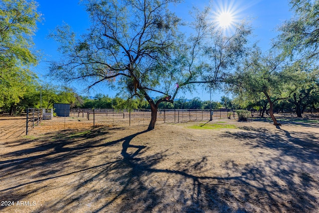 view of yard with a rural view and an outdoor structure