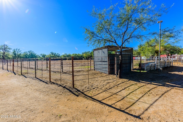 view of yard with a rural view and an outbuilding