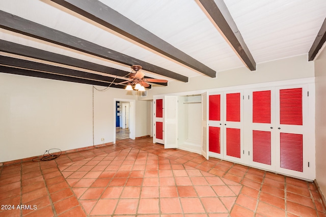 interior space with ceiling fan and beamed ceiling