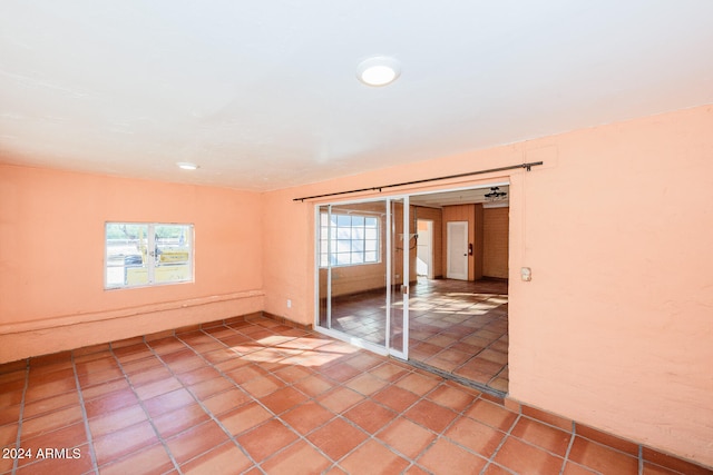 tiled spare room featuring a wealth of natural light