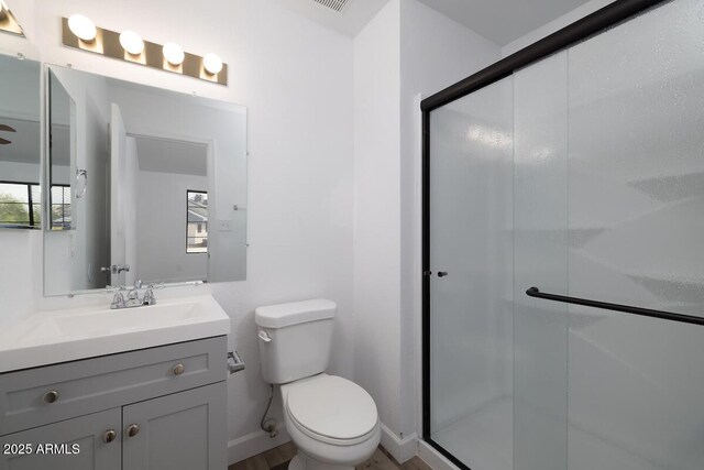7801 N 44th Dr Unit 1003, Glendale, AZ 85301 - full bathroom with toilet, vanity, a shower stall, and baseboards