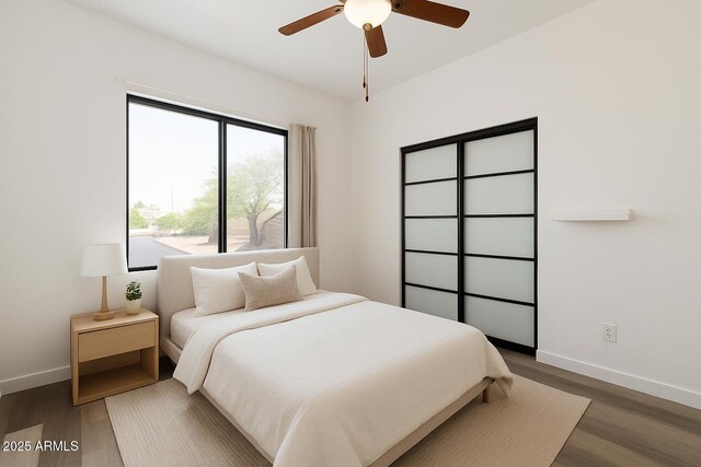 7801 N 44th Dr Unit 1003, Glendale, AZ 85301 - bedroom featuring wood finished floors, baseboards, and ceiling fan