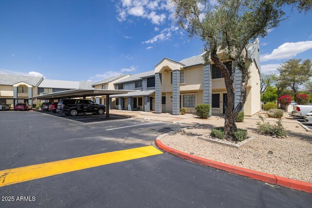 7801 N 44th Dr Unit 1003, Glendale, AZ 85301 - view of property with covered and uncovered parking and a residential view