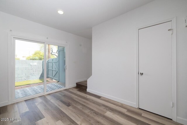 7801 N 44th Dr Unit 1003, Glendale, AZ 85301 - spare room featuring wood finished floors, baseboards, and recessed lighting