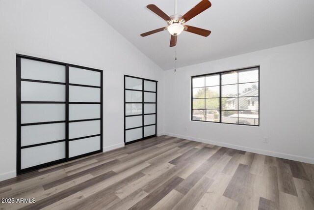 7801 N 44th Dr Unit 1003, Glendale, AZ 85301 - unfurnished bedroom featuring light wood-style flooring, baseboards, high vaulted ceiling, and ceiling fan