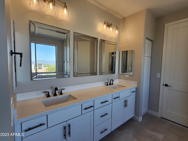 bathroom with tile floors and double vanity