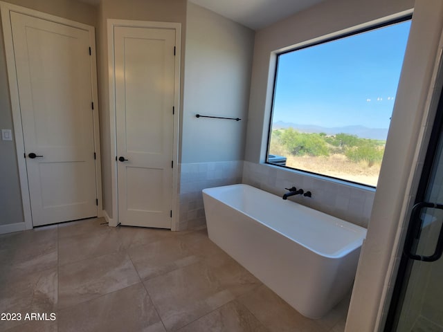 bathroom featuring a bathtub and tile floors