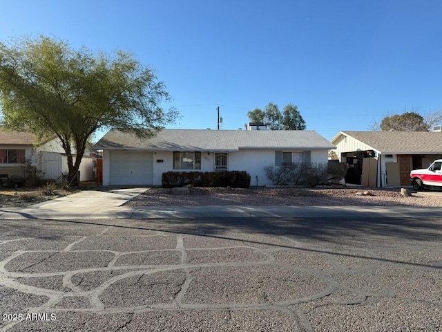 ranch-style house featuring driveway and a garage