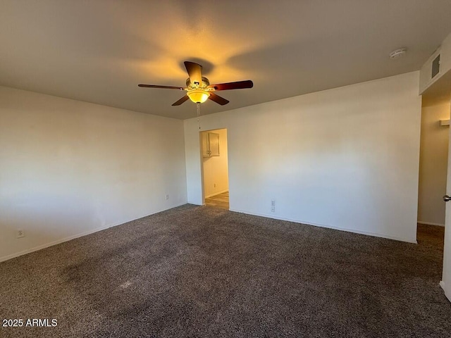 carpeted empty room featuring visible vents and ceiling fan