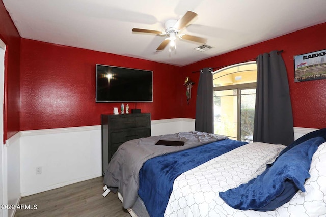 bedroom with ceiling fan and hardwood / wood-style floors