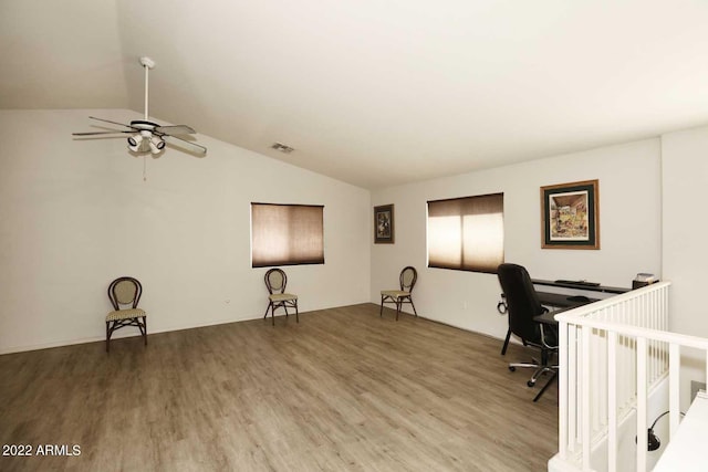 unfurnished office featuring ceiling fan, wood-type flooring, and lofted ceiling