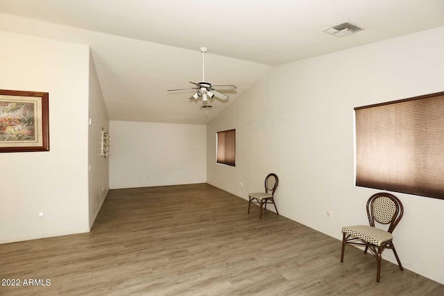 spare room with ceiling fan, lofted ceiling, and hardwood / wood-style floors