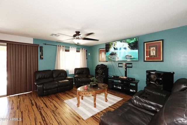 living room with hardwood / wood-style flooring and ceiling fan