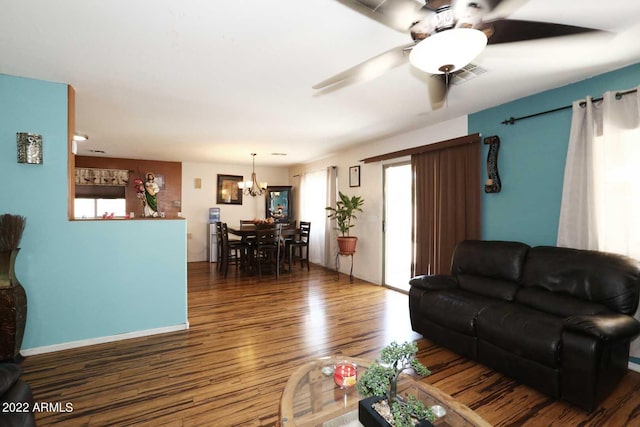 living room featuring hardwood / wood-style floors and ceiling fan with notable chandelier