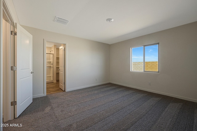 unfurnished bedroom featuring baseboards, visible vents, and dark colored carpet