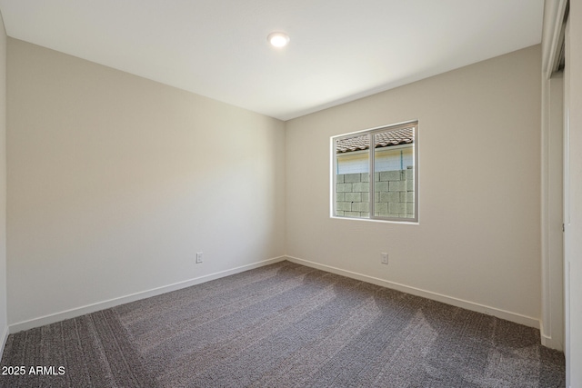 carpeted empty room with baseboards