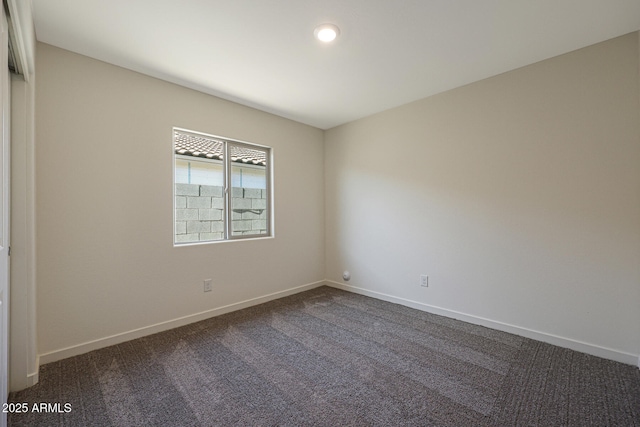 carpeted spare room with baseboards