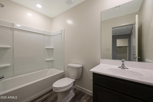 bathroom featuring visible vents, toilet, wood finished floors, vanity, and shower / bathing tub combination